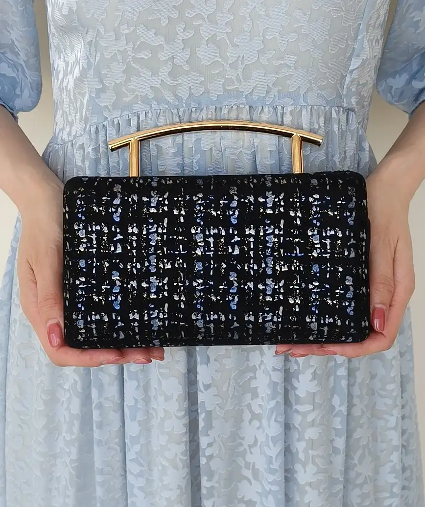 Tweed like handle clutch bag
