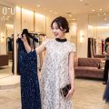 ドレスショップでパーティドレスを選ぶ女性